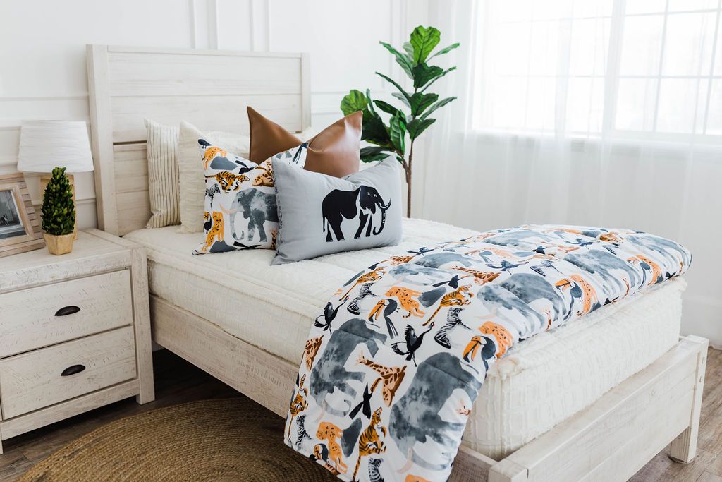 Cream bedding with textured rectangle design and faux leather euro, safari animal print pillow, gray lumbar with embroidered elephant and safari animal print blanket