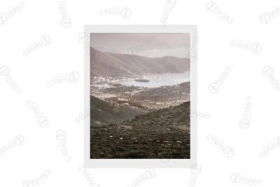A bay landscape with a small town and boats in the distance digital artwork showcased in a frame. 
