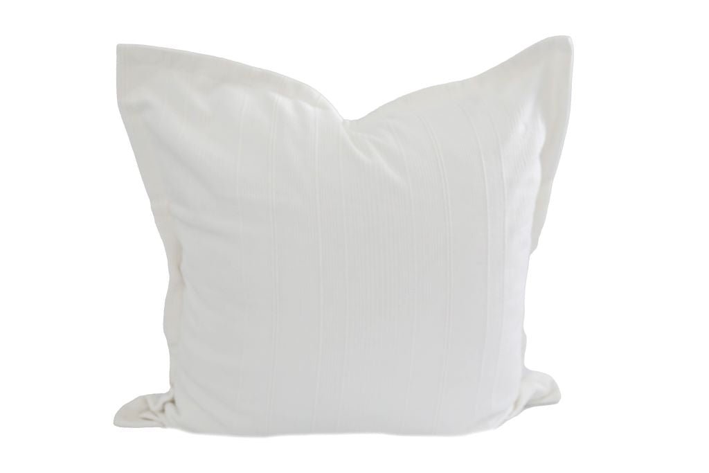 A white textured large pillow on a white background.