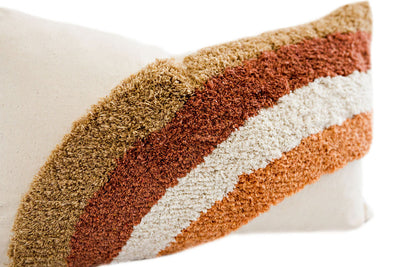 Enlarged view of a cream textured pillow with a rainbow