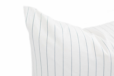 Close up of White pillow cover with blue pinstripe design