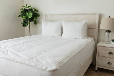 White quilted zipper bedding styled with white pillows
