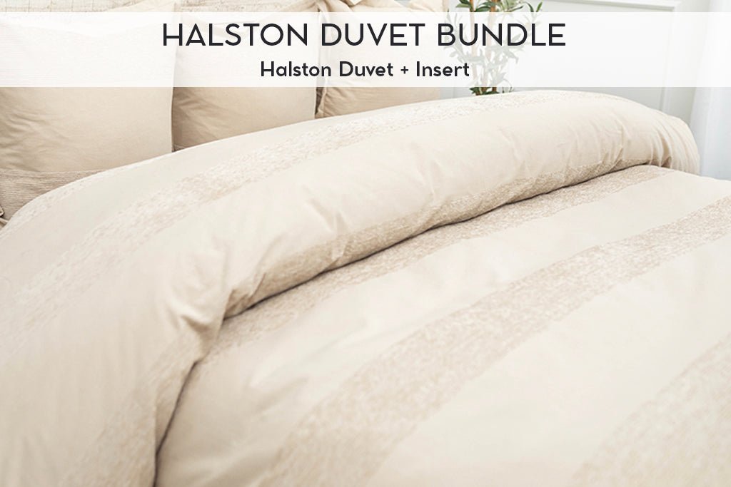 Tan duvet bedding on bed with matching accessories 