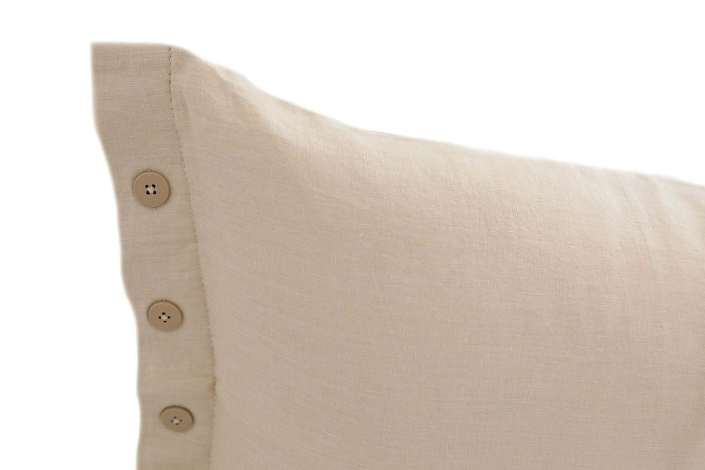 Close up of cream lumbar pillow with brown buttons
