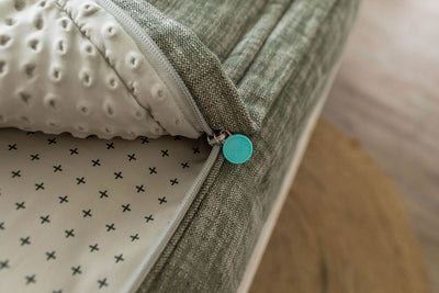 Close up view of unzipped Green zipper bedding revealing minky inner lining. Beddy's branded zipper pull tab