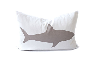 White lumbar pillow with a gray shark 