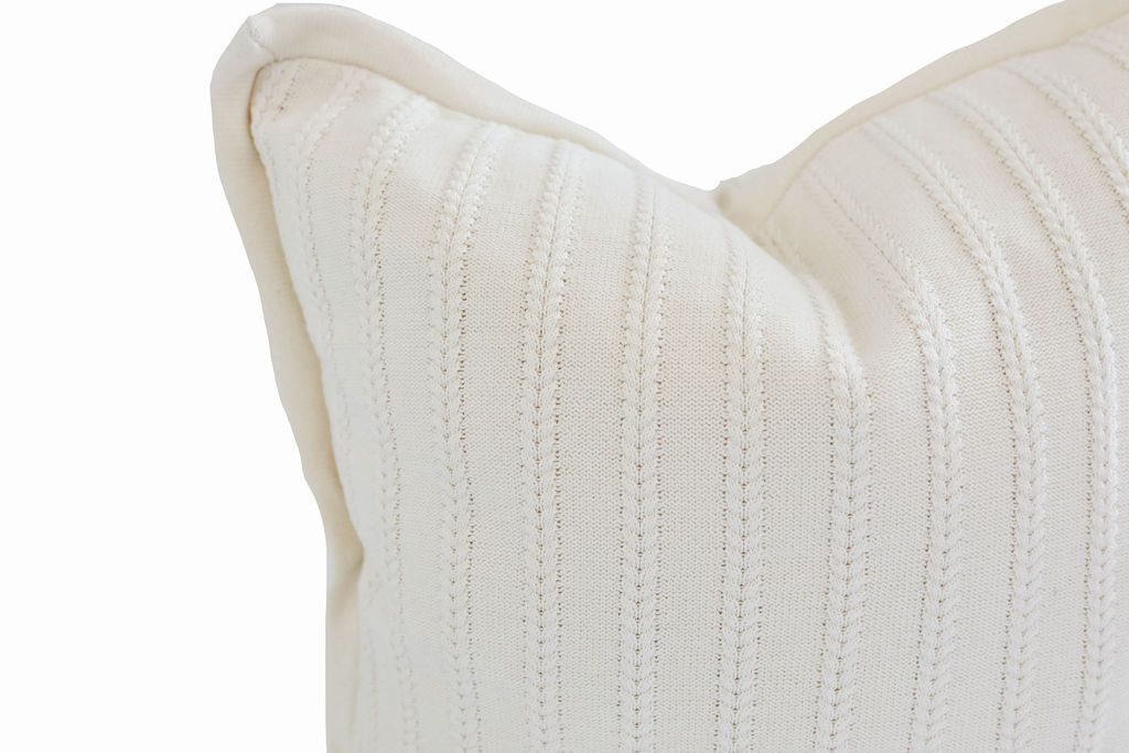 Close up of knitted cream euro pillow cover with woven vertical line pattern