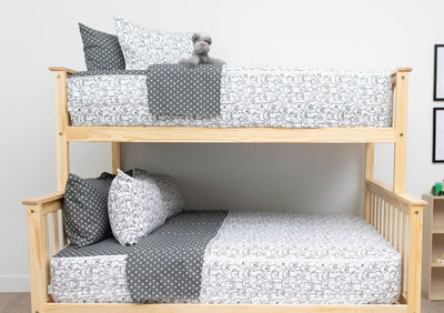 A bunk bed where both bunks are made with charcoal and white pattern dogs kids zipper bedding.