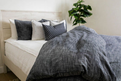 Charcoal gray duvet on white zipper bedding styled with matching gray and white pillows