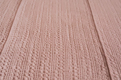 Detailed view of texture on pink zipper bedding