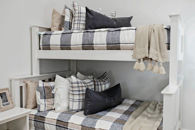 Gray, cream and white plaid zipper bedding on bunkbed. Decorated with matching pillow and cream pillow case. Black leather lumbar pillow and cream throw blanket