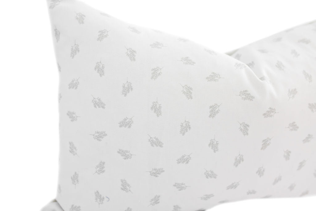 Enlarged view of a white and gray patterned lumbar pillow.