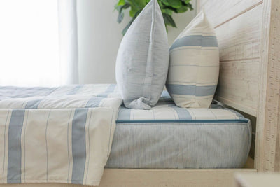 White pillowcase with horizontal light blue stitching design on blue zipper bedding