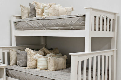 bunk bed with Taupe bedding with textured zig zag design dark creamy textured euro, a cream and tan woven textured pillow and a textured dark creamy lumbar with tassels