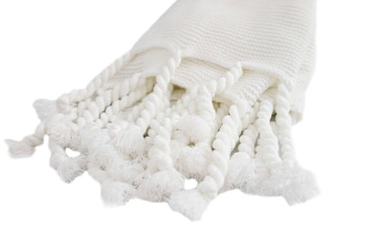 white knitted throw with braided tassels