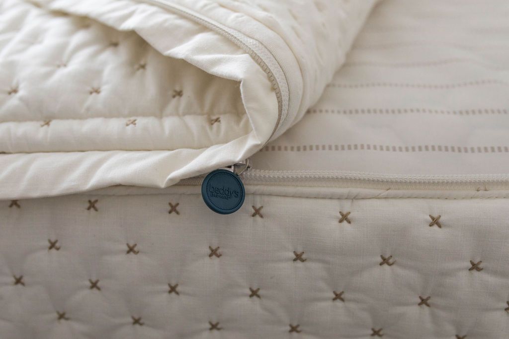 White and cream zipper bedding with brown stitching
