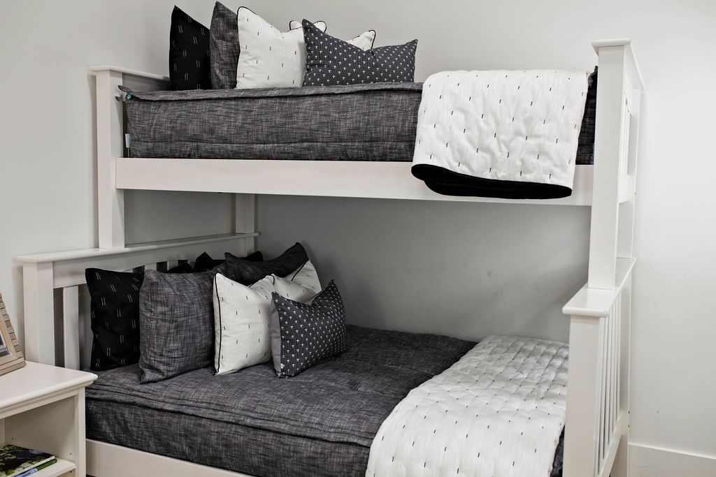 Bunk beds with Gray charcoal zipper bedding with gray, black and white pillows and white blanket