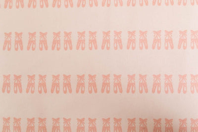 A close up of the print on a set of pink ballet shoes kids zipper bedding.