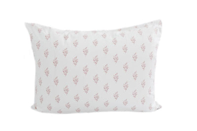A white pillowcase with a pink flower pattern design. 