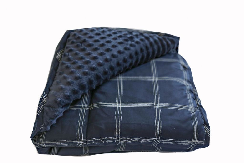 A folded navy blue children's blanket with a plaid design and minky interior.