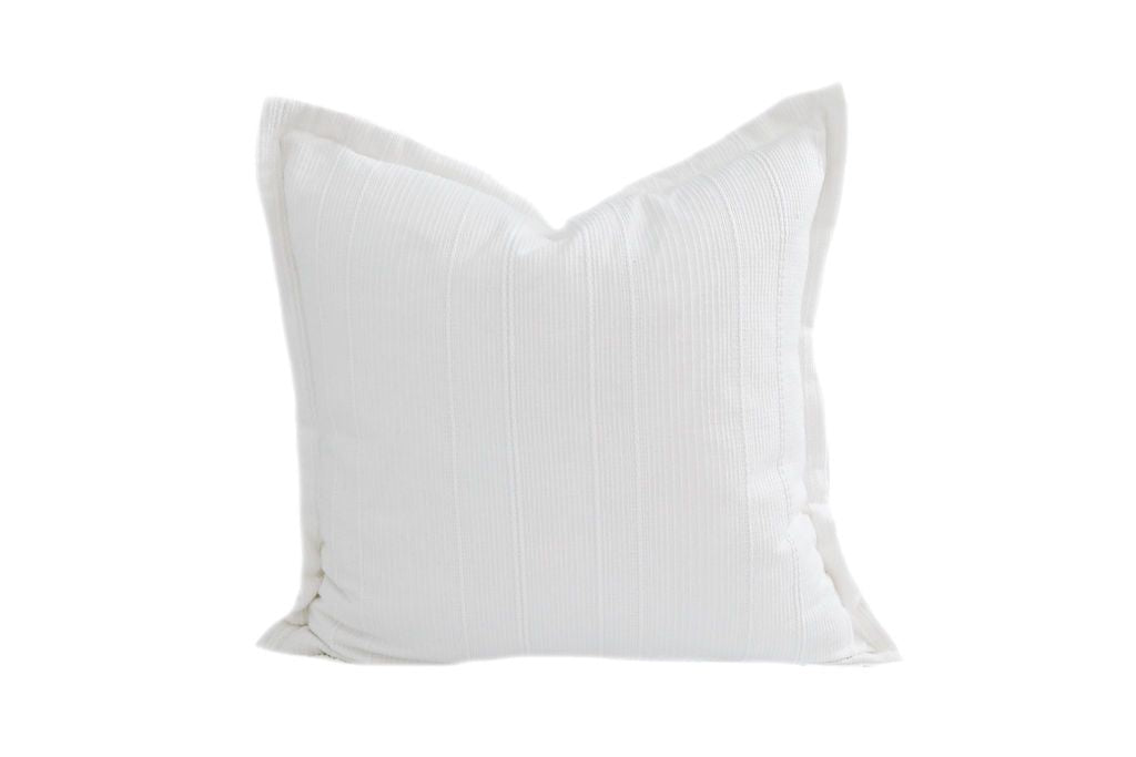 A white textured pillow on a white background.