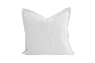 A white textured pillow on a white background.