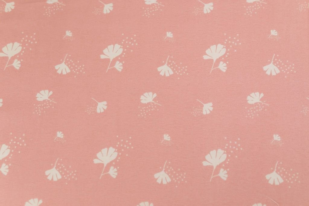 A close up of the interior of a set of pink, blue, and yellow floral kids zipper bedding.