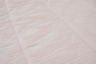 Close up of pink zipper bedding detailing bedding texture