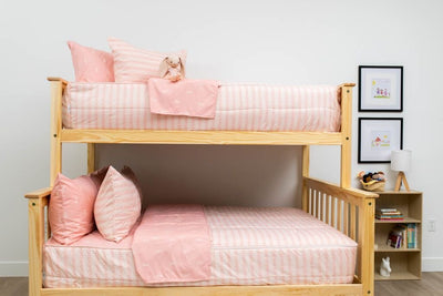 A bunk bed where both bunks are made with pink ballet shoes kids zipper bedding.