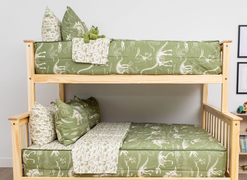 A bunk bed where both bunks are made with olive green dinosaur fossils kids zipper bedding.