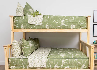 A bunk bed where both bunks are made with olive green dinosaur fossils kids zipper bedding.