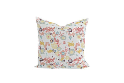 A multi-colored watercolor floral pattern pillow on a white background.