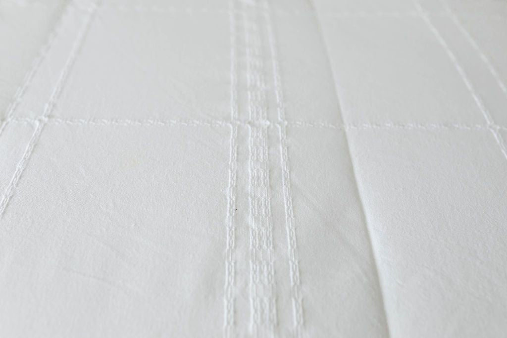 Detailed view of texture on white zipper bedding