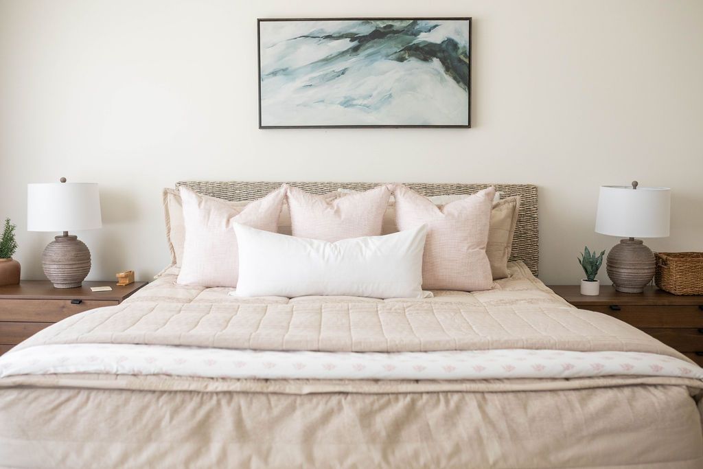 Tan zipper bedding styled with tan, white and cream pillows and tan and white blankets