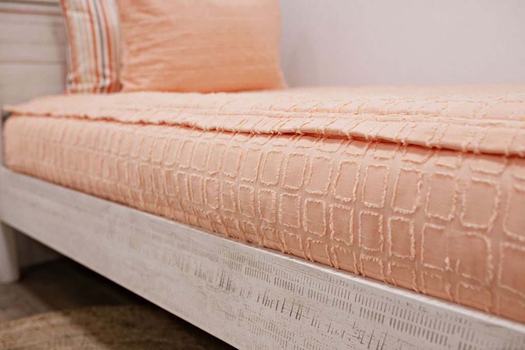 peach bedding with textured rectangle design