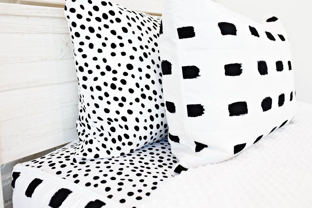 Enlarged view of a white and black spotted pillowcase and a white and black dash sham.