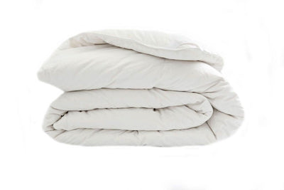 A side few of a white down duvet insert folded. 