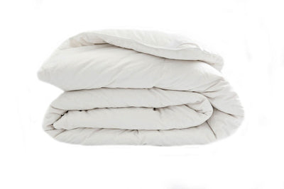 A side few of a white down duvet insert folded. 