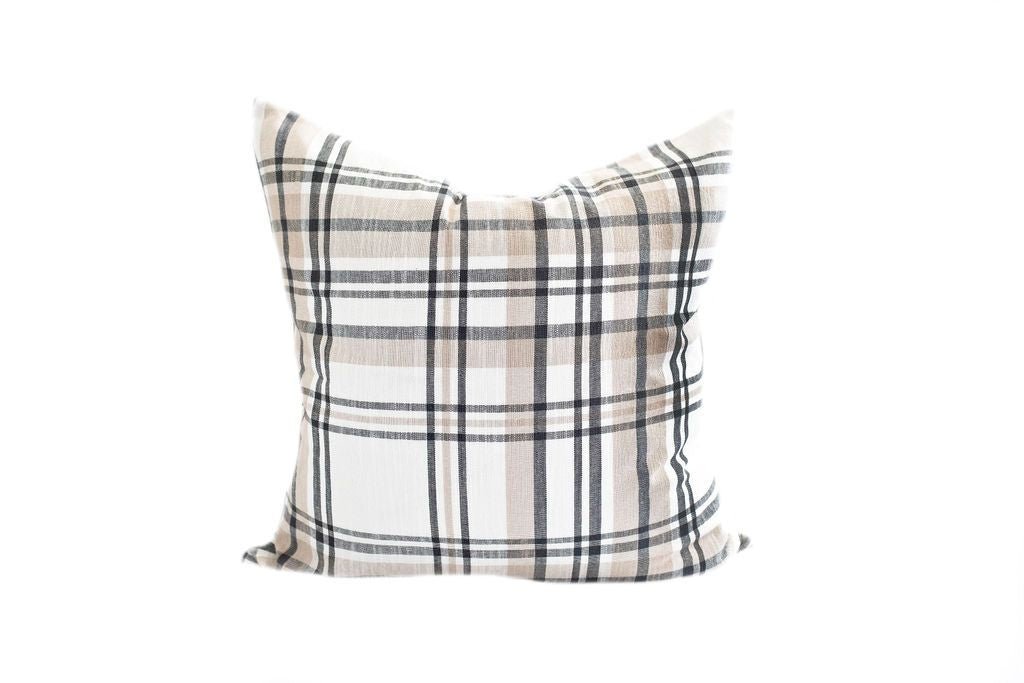 A cream, charcoal gray, and tan plaid design pillow on a white background.