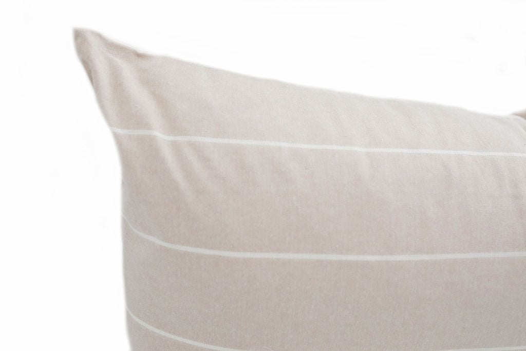 Close up of Cream lumbar pillow with white stripes