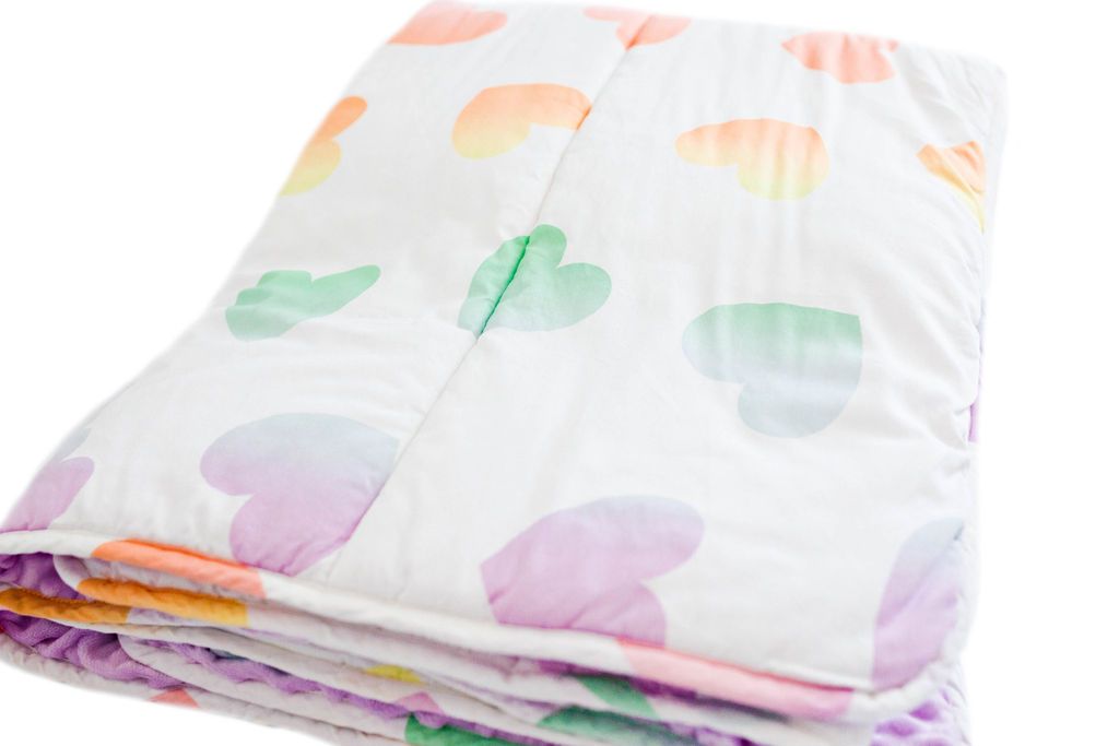 white blanket with ombre rainbow hearts