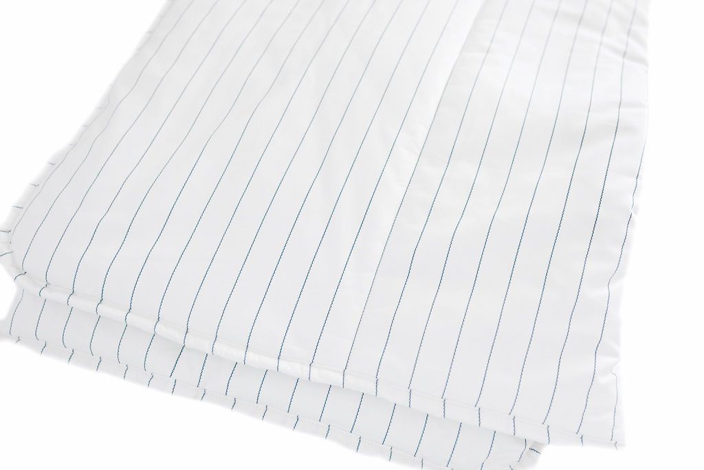 A white and light thin blue striped blanket folded.