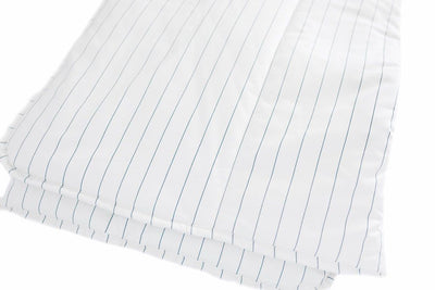 A white and light thin blue striped blanket folded.