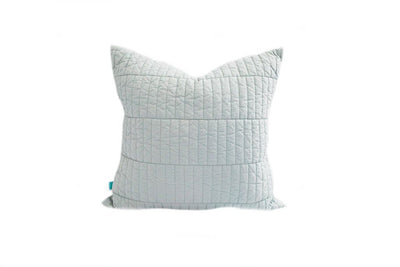 A light blue quilted pillow on a white background.