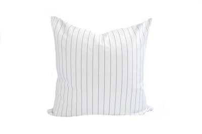 A white and thin navy blue striped pillow on a white background.
