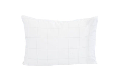 A white pillowcase with faint light gray grid pattern.
