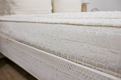 side of cream bedding with textured rectangle design