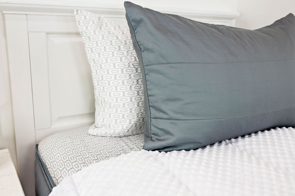 Enlarged view of a white and gray patterned pillowcase and a gray sham. 
