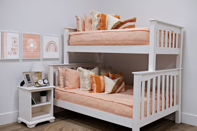 bunk bed with peach textured bedding and Peach bedding with textured rectangle design with dark cream textured euro, orange, textured pillow with tassels, rainbow lumbar, rainbow, flower, you are sunshine artwork