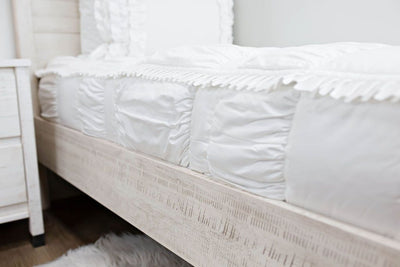 Up close side view of white textured bedding
